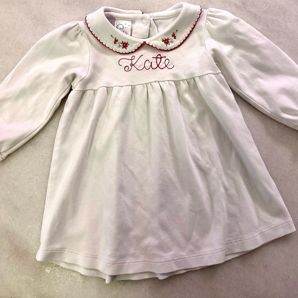 Soft, knit top or dress with embroidered floral collar and “kate” monogram